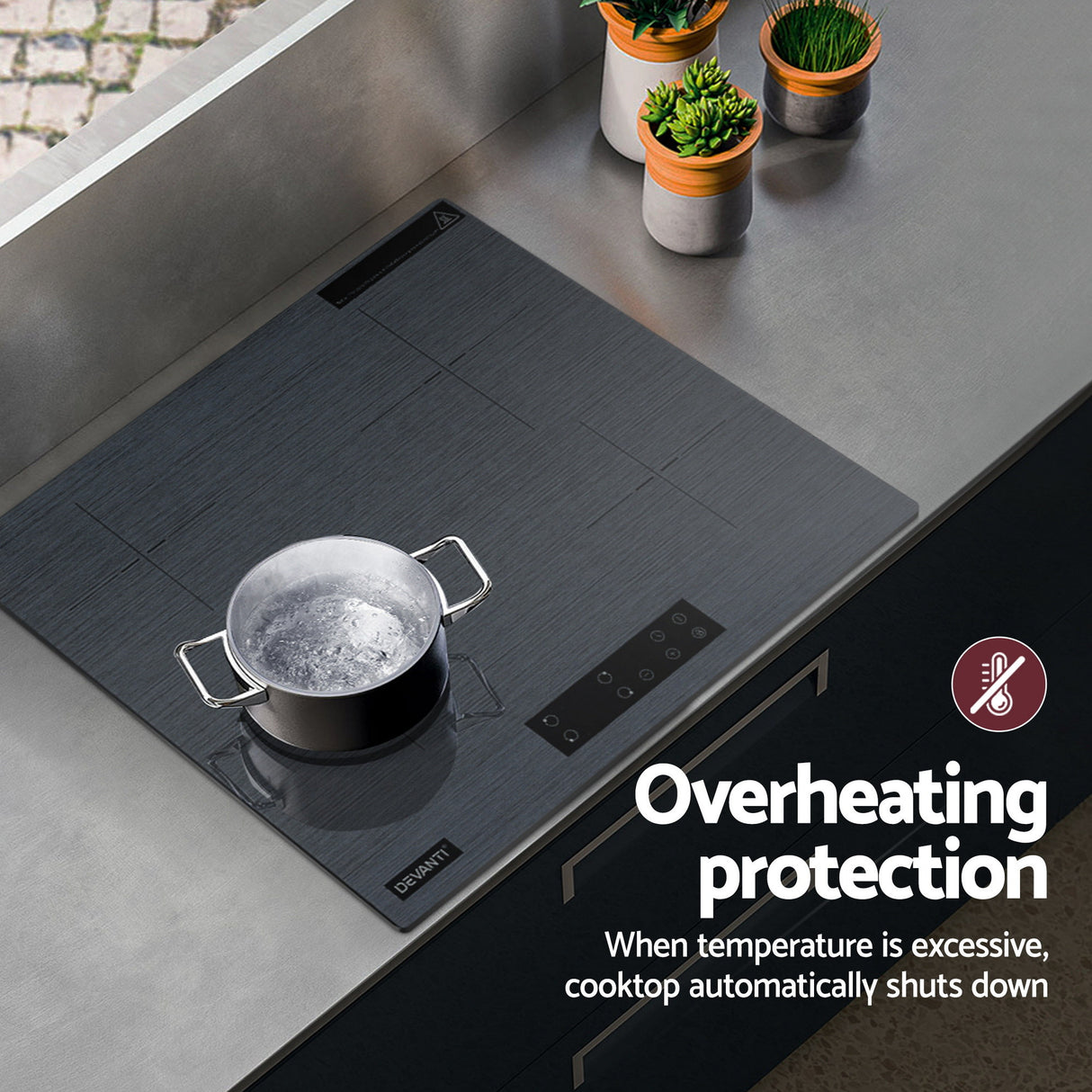 Grey cooktop in a modern kitchen with dark cabinetry