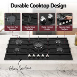 Burners lit on the 90 cm black tempered glass gas cooktop