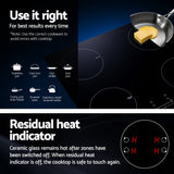 Underside of the induction cooktop showing the cooling fan and wiring connection