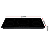 Wide black glass induction cooktop built flush into a kitchen benchtop