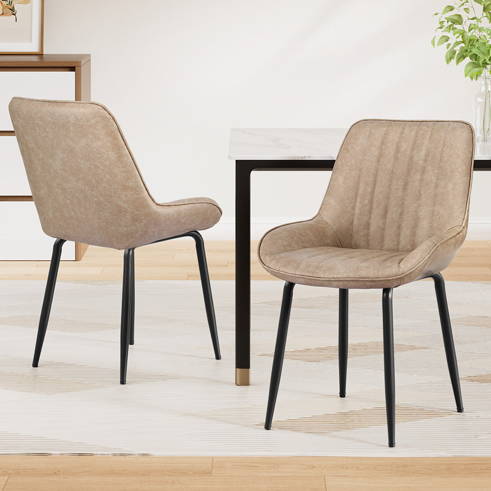 Nain khaki faux leather dining chair with black metal legs in a modern dining room