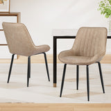 Nain khaki faux leather dining chair with black metal legs in a modern dining room