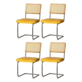 Macclesfield yellow velvet cantilever dining chairs with stainless steel frame in a dining room