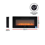 Electric fireplace insert recessed flush into a feature wall