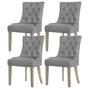 Summertown grey linen French Provincial tufted dining chairs with solid wood legs in a dining room