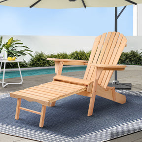 Brundee natural hemlock wood Adirondack chair with slide out ottoman in a garden