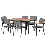 Seven piece outdoor dining set arranged on a patio