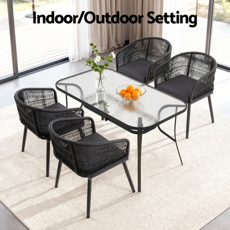 Black five piece rattan and glass outdoor dining set
