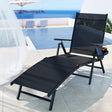 Black textilene reclining sun lounger beside a pool