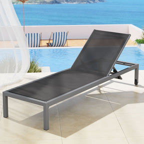 Dark grey textilene reclining sun lounger beside a pool