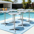 Modern silver outdoor bar setting with stools and table on a patio