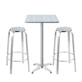 Black Rock silver aluminium 3 piece outdoor bar set with two stools and adjustable table on a patio
