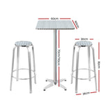 Black Rock silver aluminium 3 piece outdoor bar set with two stools and adjustable table on a patio