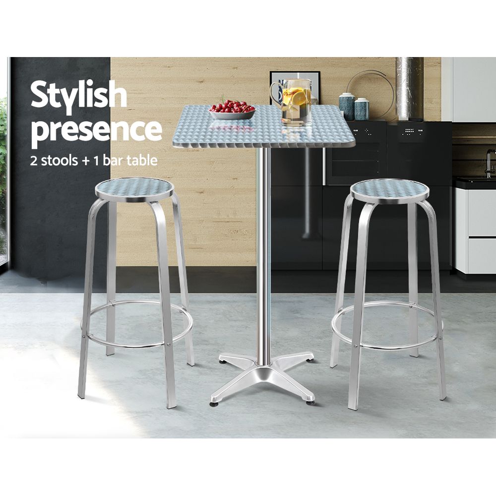 Black Rock silver aluminium 3 piece outdoor bar set with two stools and adjustable table on a patio