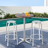 Black Rock silver aluminium 3 piece outdoor bar set with two stools and adjustable table on a patio