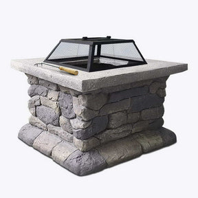Litchfield 55cm square rustic fire pit table with safety mesh dome on a patio