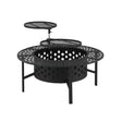 Stokes Bay 91cm 3 in 1 steel fire pit, BBQ and table with star cut out design in a backyard