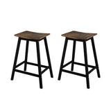 Edithvale rustic brown wooden bar stool with saddle seat in an industrial kitchen