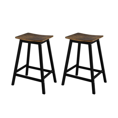 Edithvale rustic brown wooden bar stool with saddle seat in an industrial kitchen