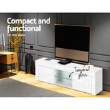 Southport white 130cm high gloss entertainment unit with glass shelves in a modern living room