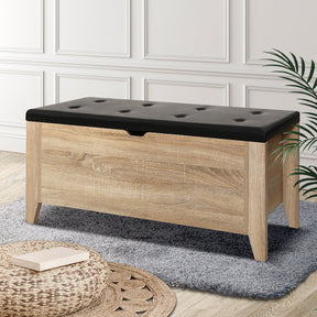 Freshwater Creek leather storage ottoman blanket box with oak legs in a living room