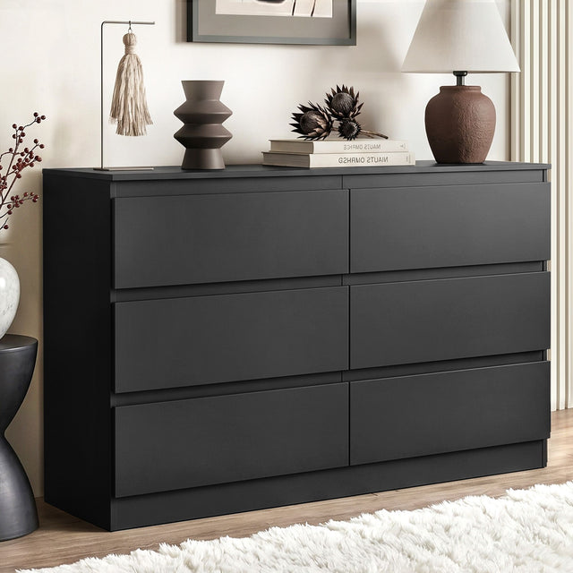 Sienna white and black 6 drawer lowboy with groove handle in a modern bedroom
