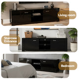 Snug black 160cm entertainment unit with cabinets and shelves in a modern living room