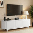 Penguin white 160cm fluted TV entertainment unit with side cabinets and open shelving in a lounge room