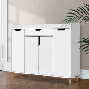 Collins white two door adjustable shoe rack cabinet holding 26 pairs in an entryway