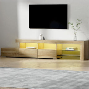 Penguin 215cm pine LED entertainment unit with colour changing lighting and glass shelves in a modern living room