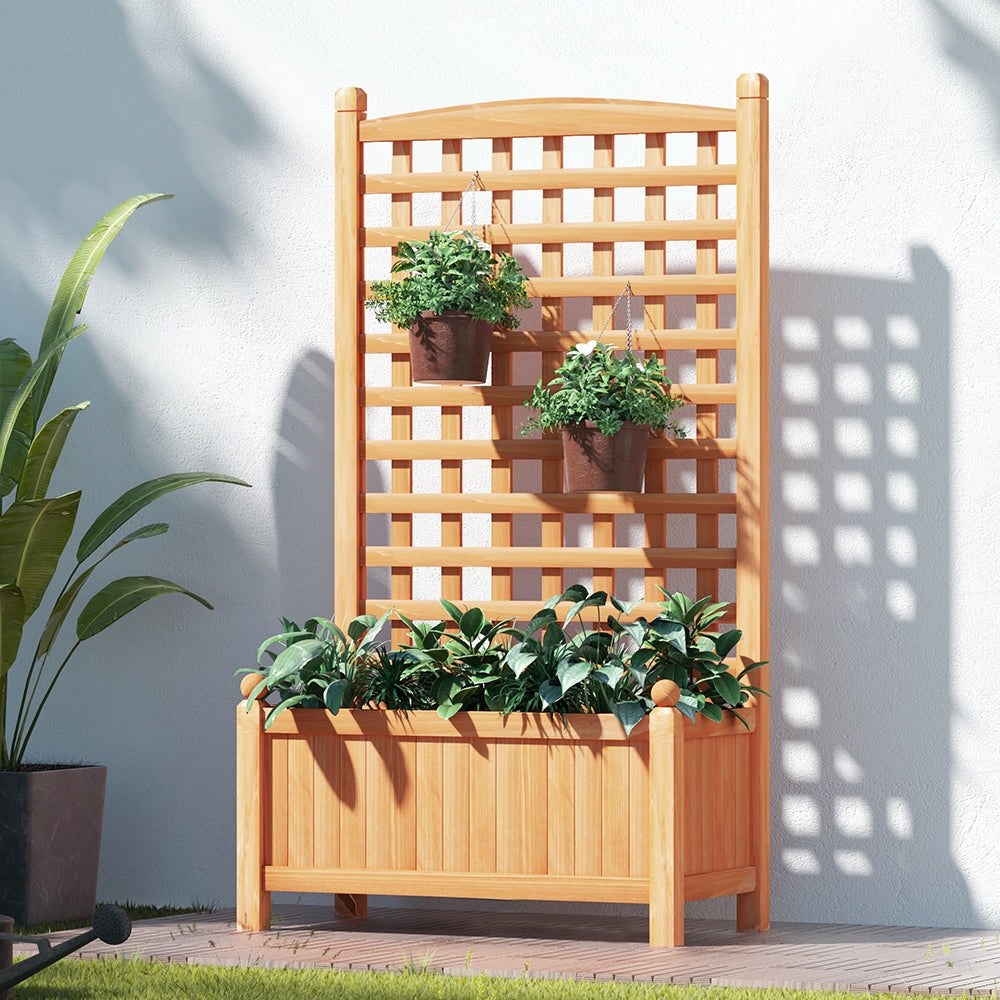 Brown wooden raised garden bed with tall climbing trellis planted with flowers