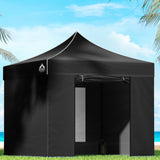 Black 3 x 3 m pop up gazebo with side walls set up outdoors