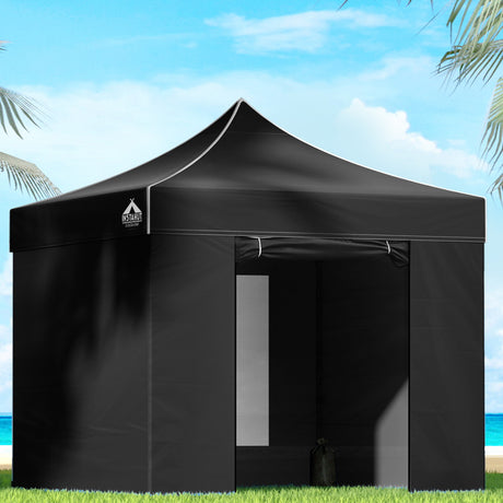Black 3 x 3 m pop up gazebo with side walls set up outdoors