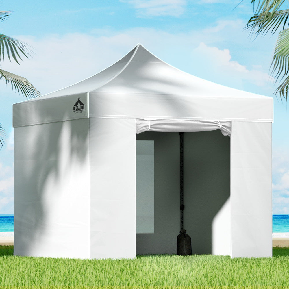 White 3 x 3 m pop up gazebo with side walls set up outdoors