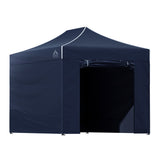 Navy gazebo packed down beside its carry bag ready for transport
