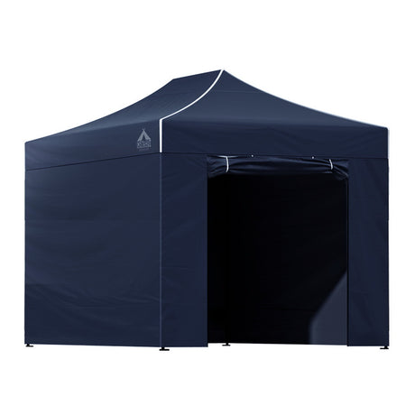 Navy gazebo packed down beside its carry bag ready for transport