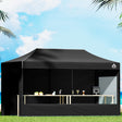 Black 3 x 6 m pop up gazebo erected outdoors with steel frame and long canopy