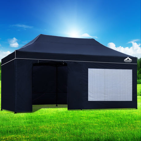 Oxford weave carry bag holding the folded navy gazebo and its wall panels