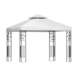 White iron art gazebo shading an outdoor wedding and dining setting