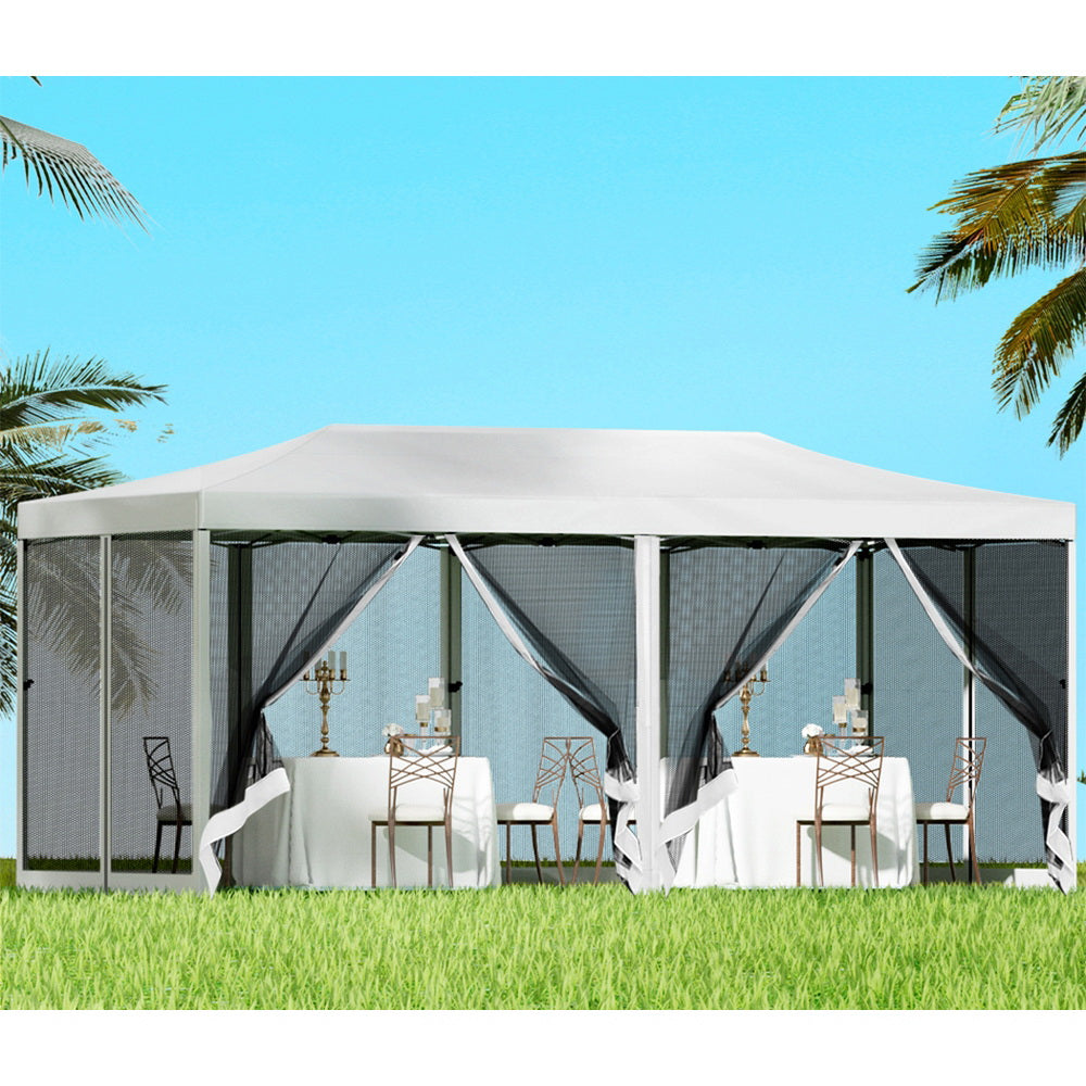 White 3 x 6 m pop up gazebo set up outdoors with mesh side walls zipped closed