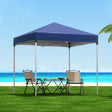Blue 2 x 2 m pop up gazebo set up on grass in a backyard