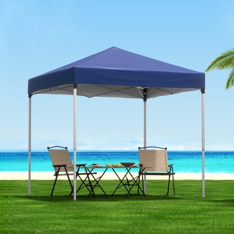 Blue 2 x 2 m pop up gazebo set up on grass in a backyard