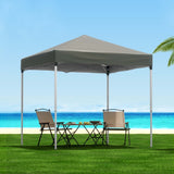 Grey 2 x 2 m pop up gazebo set up on a lawn
