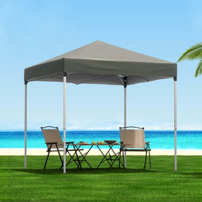 Grey 2 x 2 m pop up gazebo set up on a lawn