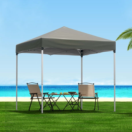 Grey 2 x 2 m pop up gazebo set up on a lawn