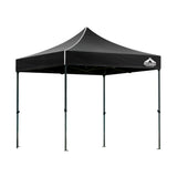 Black pop up gazebo shown providing shade at an outdoor event