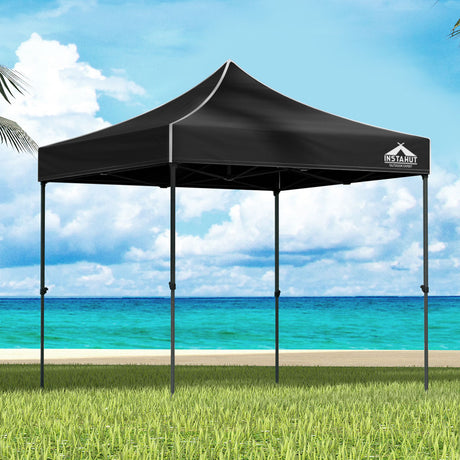 Black 3 x 3 m pop up gazebo set up outdoors with open sides