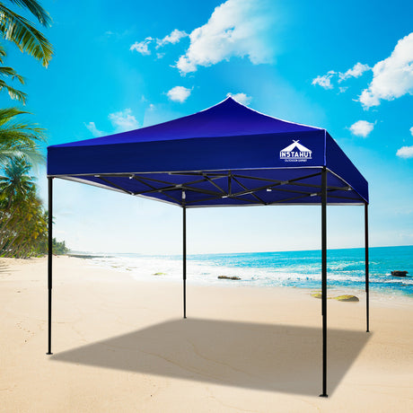 Blue pop up gazebo partly folded during set up
