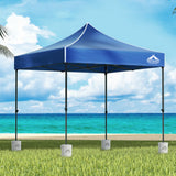 Blue 3 x 3 m pop up gazebo with four base pods set up outdoors