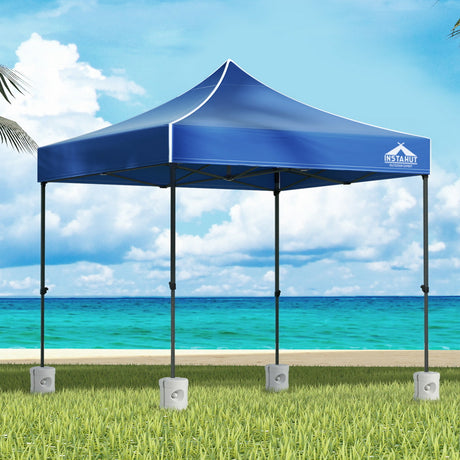 Blue 3 x 3 m pop up gazebo with four base pods set up outdoors
